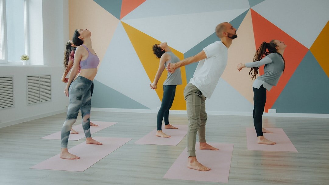 Seniors practicing gentle yoga and stretching exercises in a bright studio