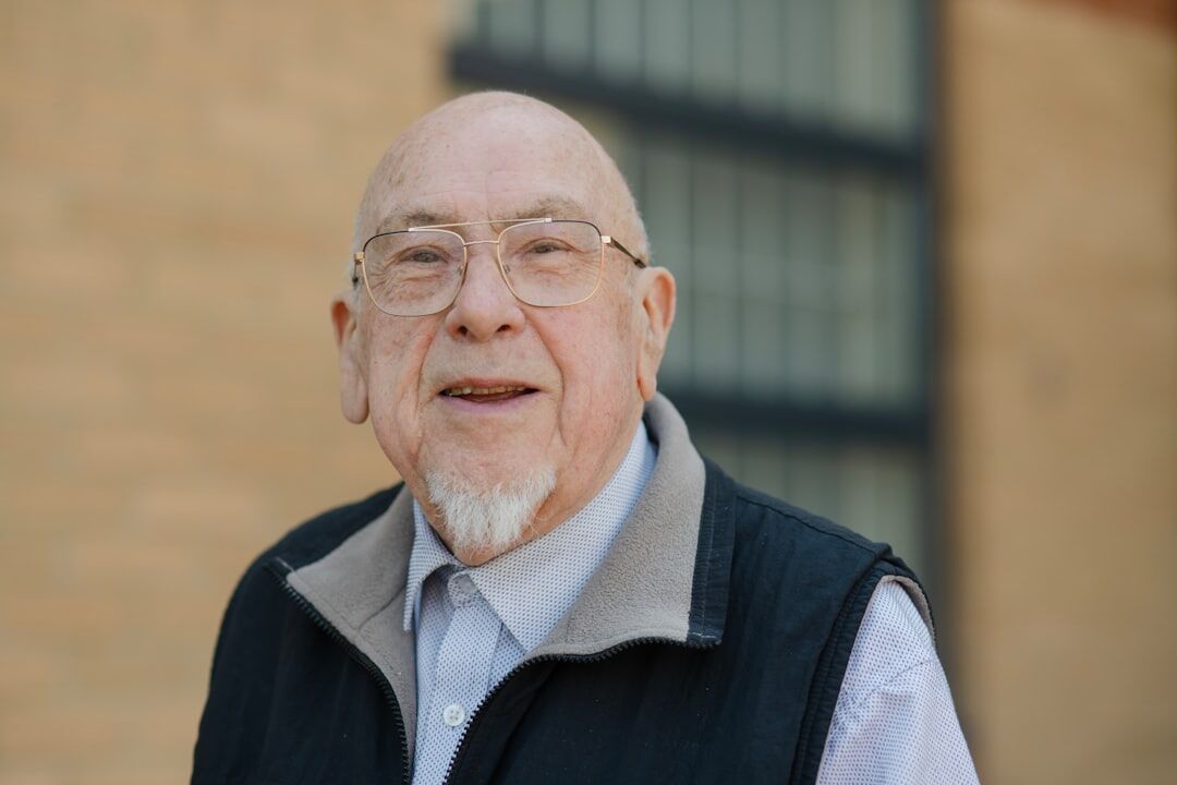 Portrait of a smiling senior man with white hair and glasses