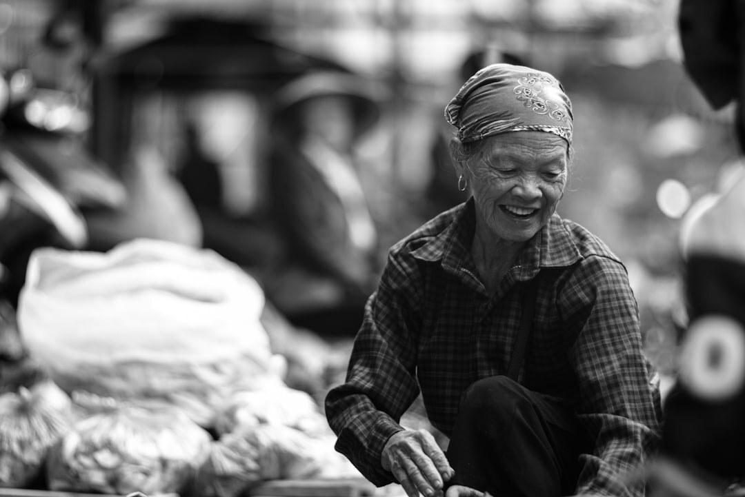 Senior woman smiling while shopping at a local market with a discount card