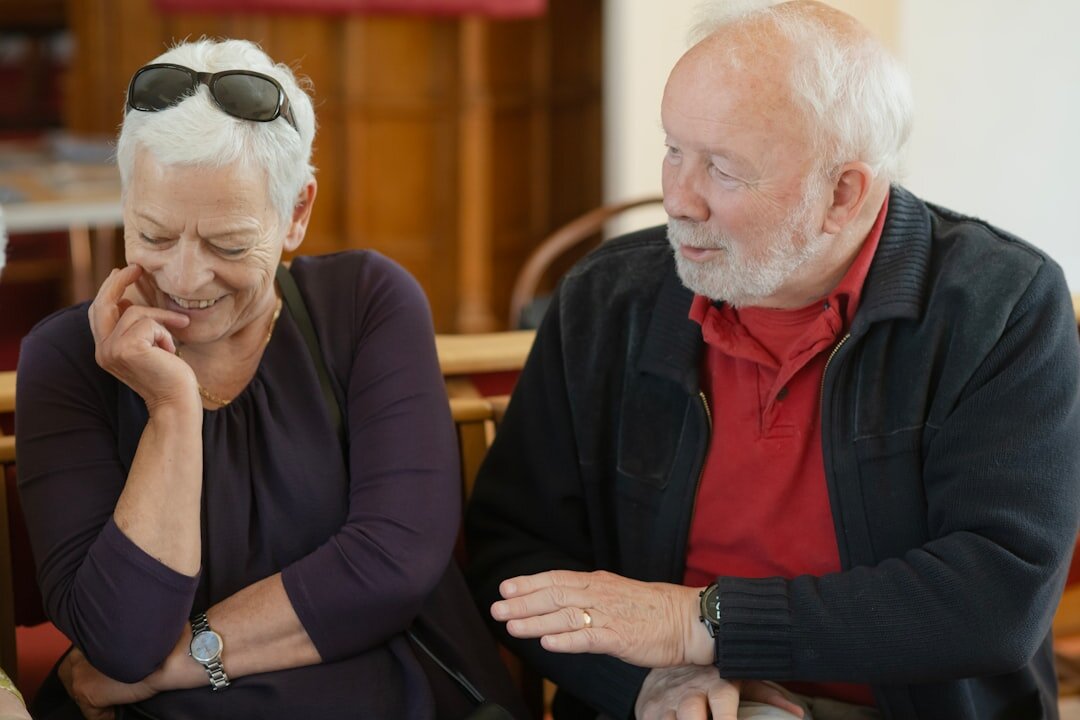 Senior man and woman reviewing a membership card and documents together